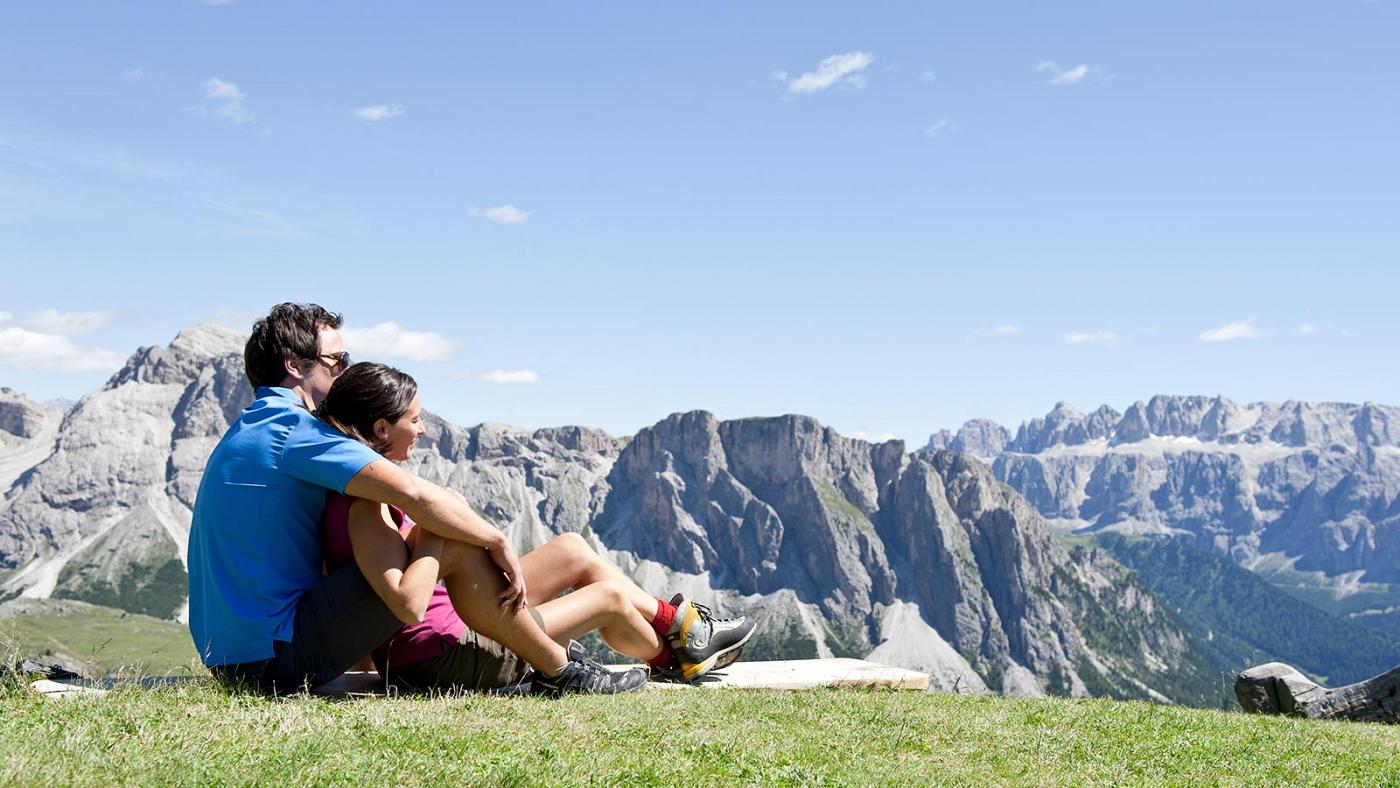 A couple enjoys the view across Sellaronda in Val Gardena Italy