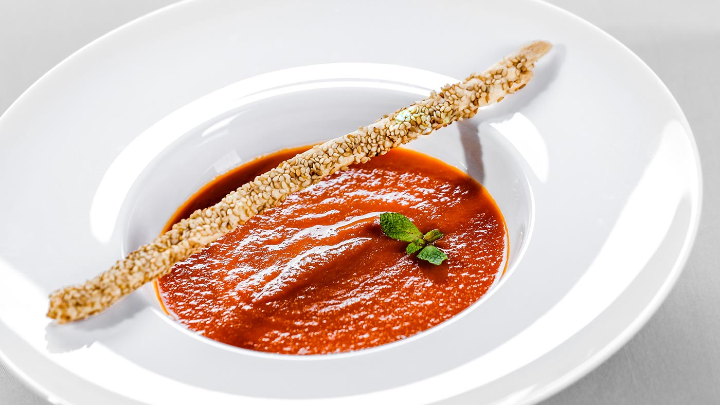Tasty tomato soup with sesame breadstick