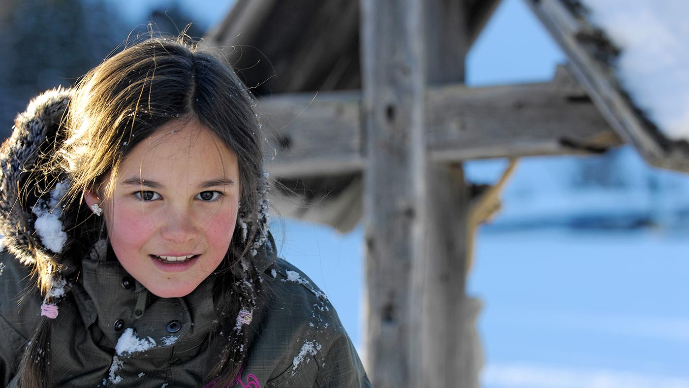 A girl plays on the snow